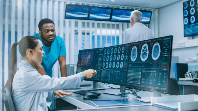 Medical,Scientist,And,Surgeon,Discussing,Ct,Brain,Scan,Images,On